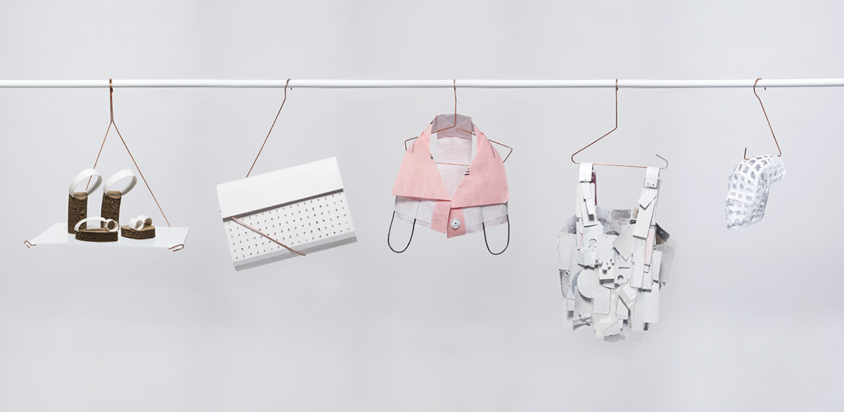 White paper accessory collection showcased on copper custom made hangers